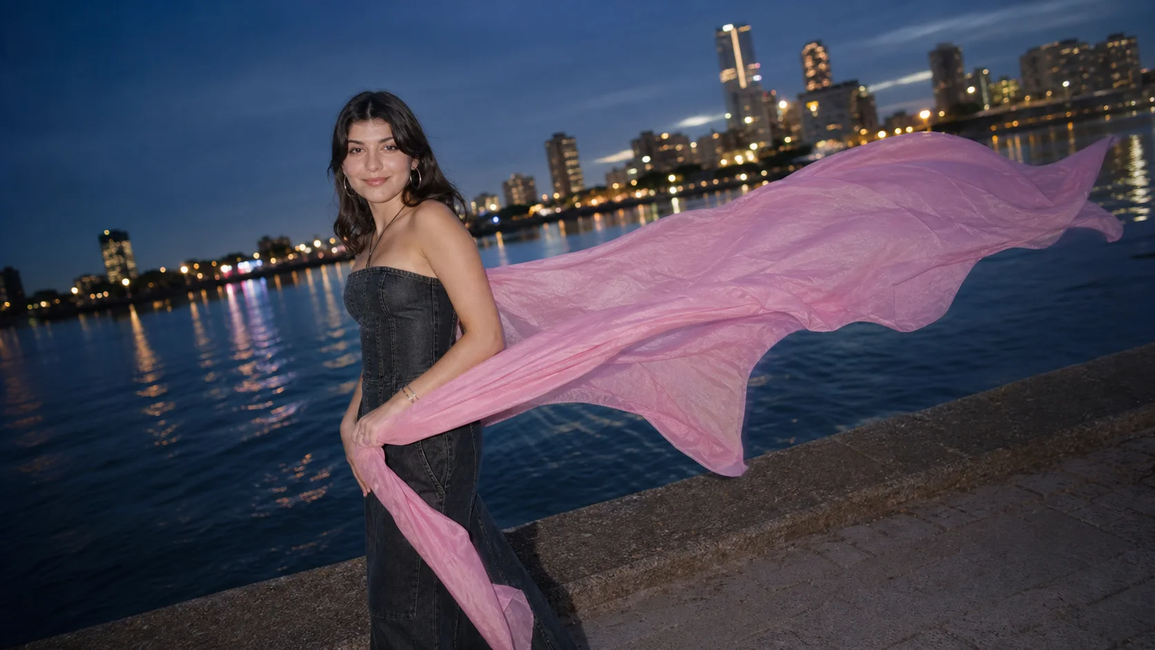Kenzie Sky at blue hour on a waterfront with rose-pink silk moving in the wind